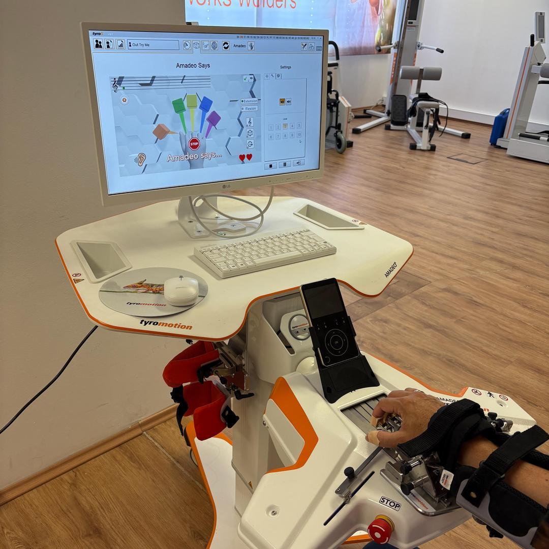 Finger-Hand Device Amadeo and hand of a patient that is playing the new Amadeo Says Game