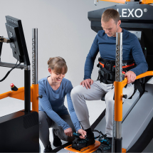 Therapist closes foot attachement of patient on Lexo robotic gait trainer