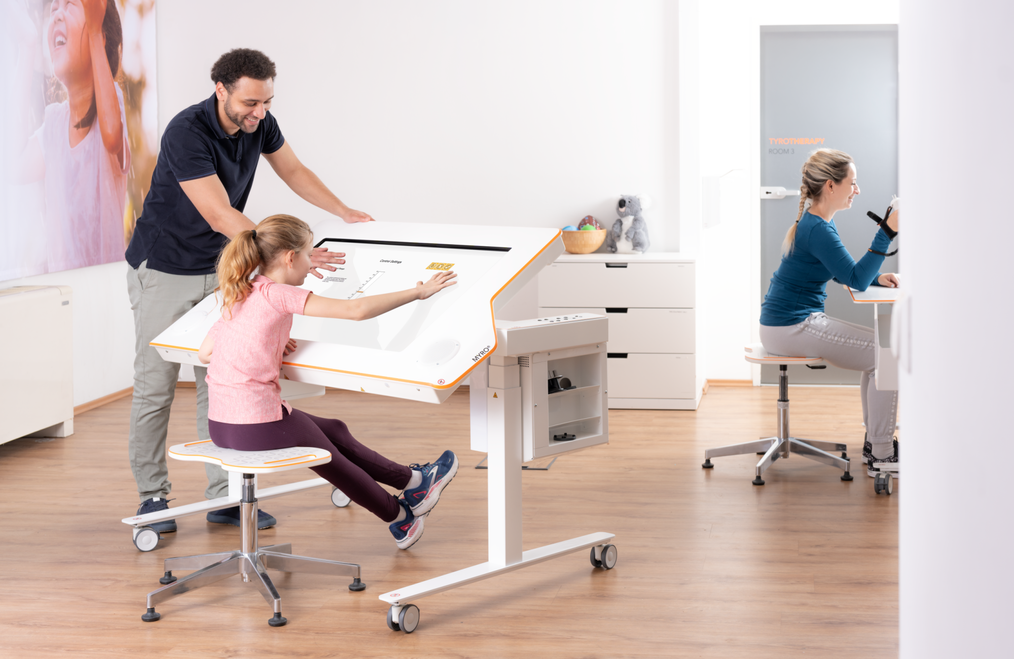 Child and therapist train with Myro