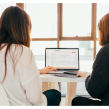 Two Therapists looking at software on a laptop for therapists