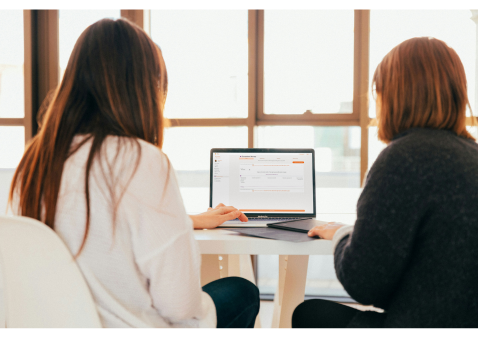 Two Therapists looking at software on a laptop for therapists