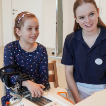 Child doing robotic upper limb rehabilitation with Amadeo