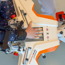 Child's hands on hand therapy device Amadeo