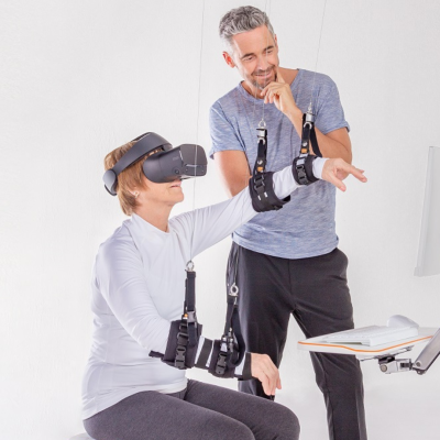 Patient trains with VR on arm rehabilitation device Diego