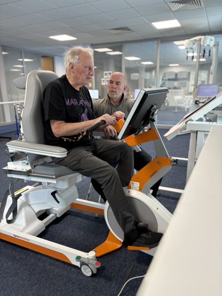 Patient trains on Omego leg rehabilitation device