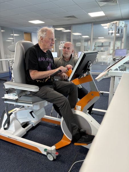 Patient trains on Omego leg rehabilitation device