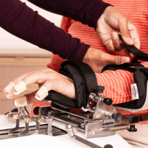 Therapists secures Patients hand on Amadeo
