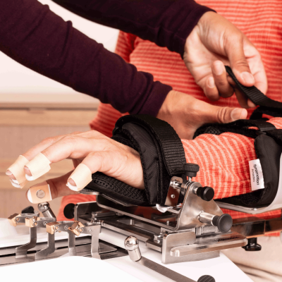 Therapists secures Patients hand on Amadeo