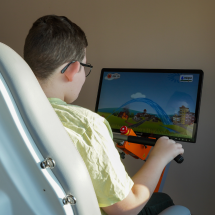 Child playing games while training with Omego Plus