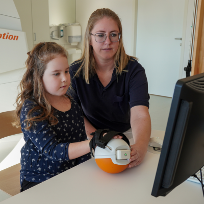 Girl trains with hand grip measurement device Pablo