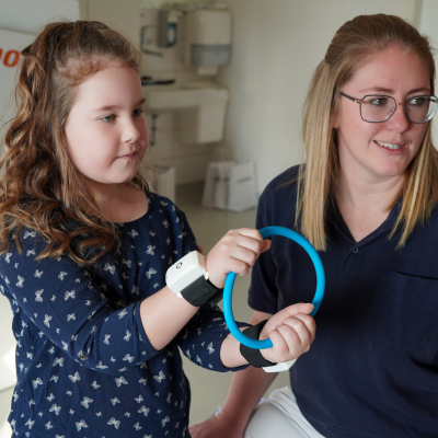 Girl training with wrist rehabilitation device Pablo