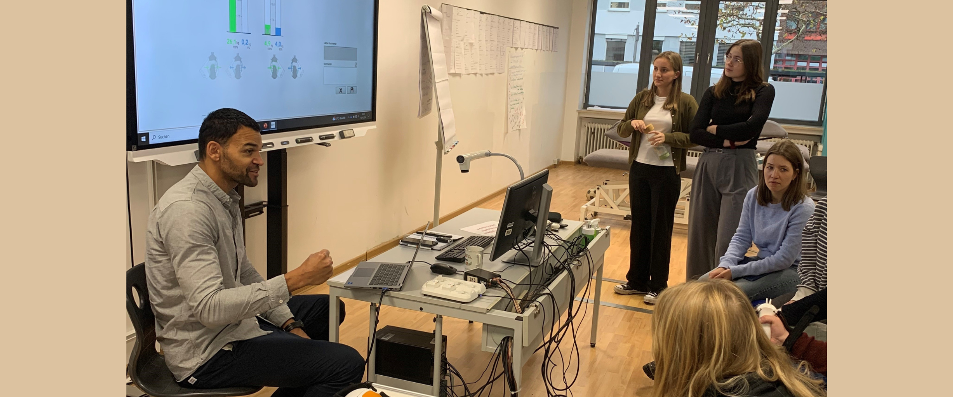 A therapist presenting in front of a group of people in a therapy room