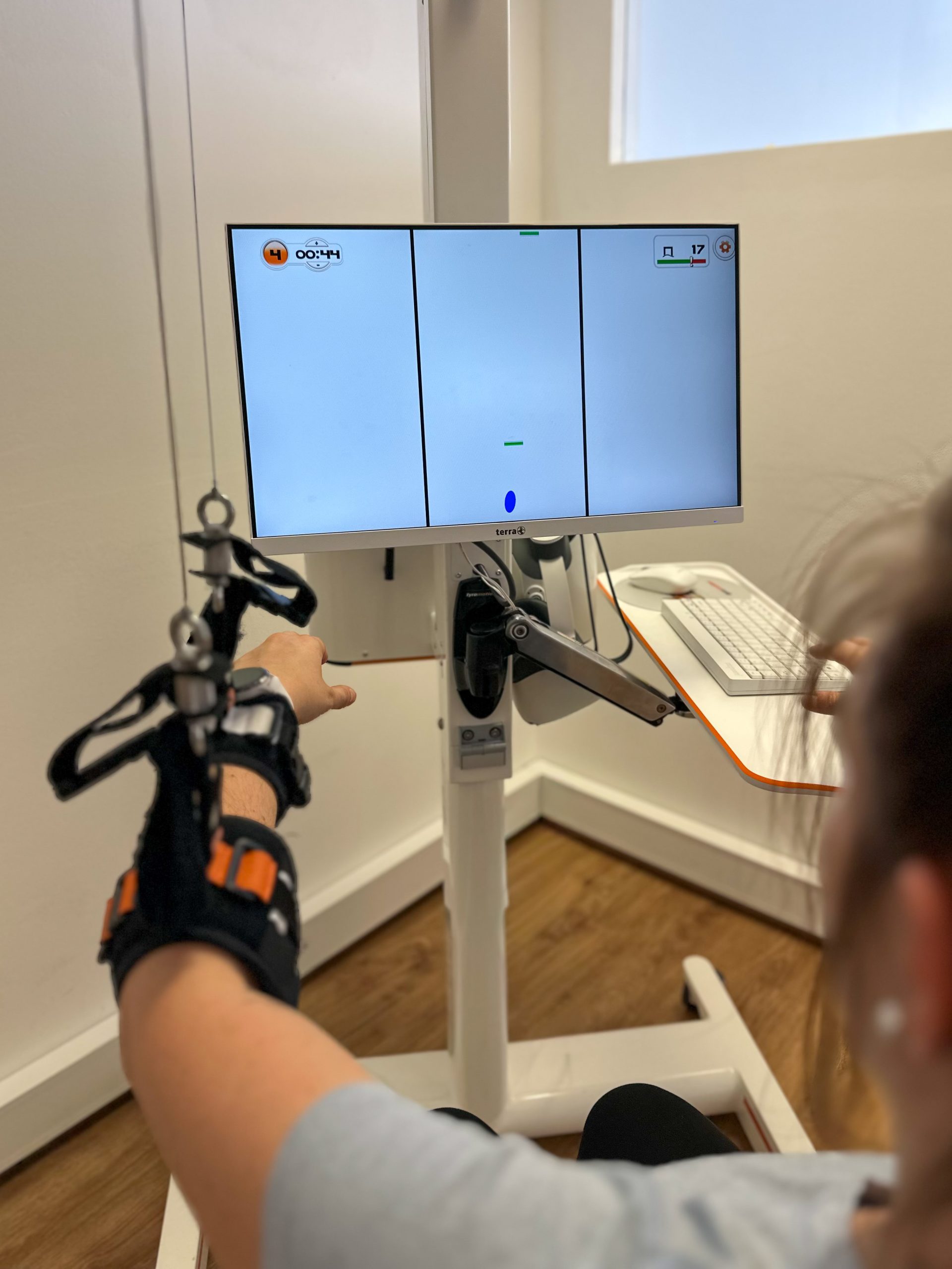 A patient sitting at Myro and playing the new tyroS 6.8 game Paddle Boat