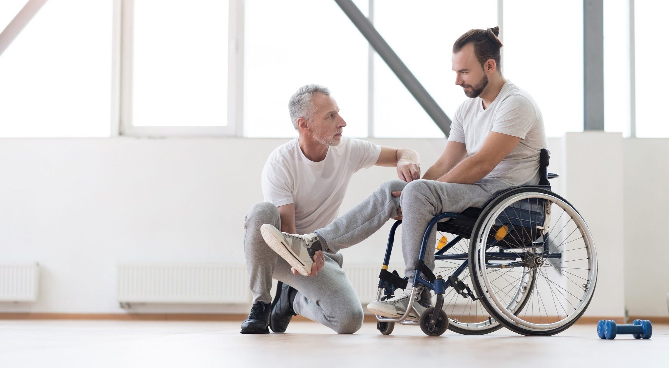 Therapist and a men in a wheelchair providing heathcare class