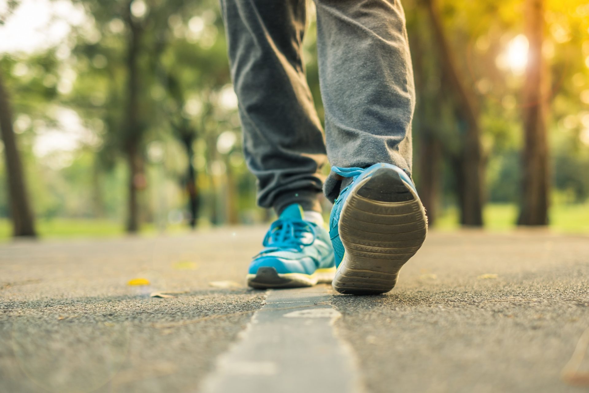 Feet with sport shoes from a woman walking in the park