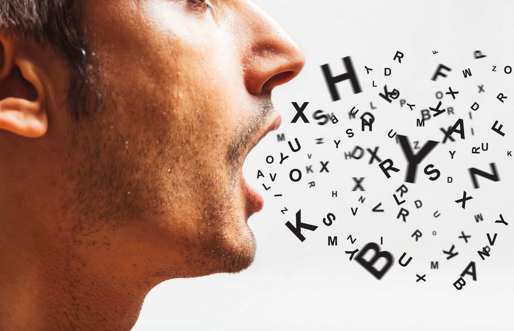 A person with open mouth and a lot of letters coming out