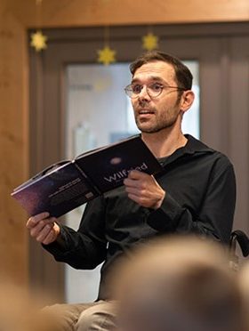 Werner David W. from Graz, Austria holding a book in his hands