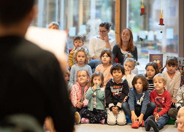Werner David W. from the back sitting in front of a group of children reading from a book