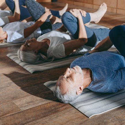 Two men and two women in a relaxing Yoga position