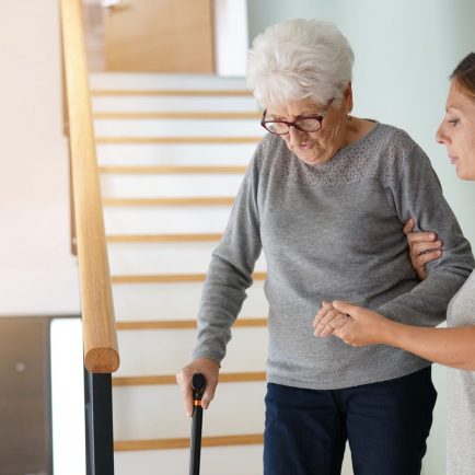 elderly woman gets help from therapist