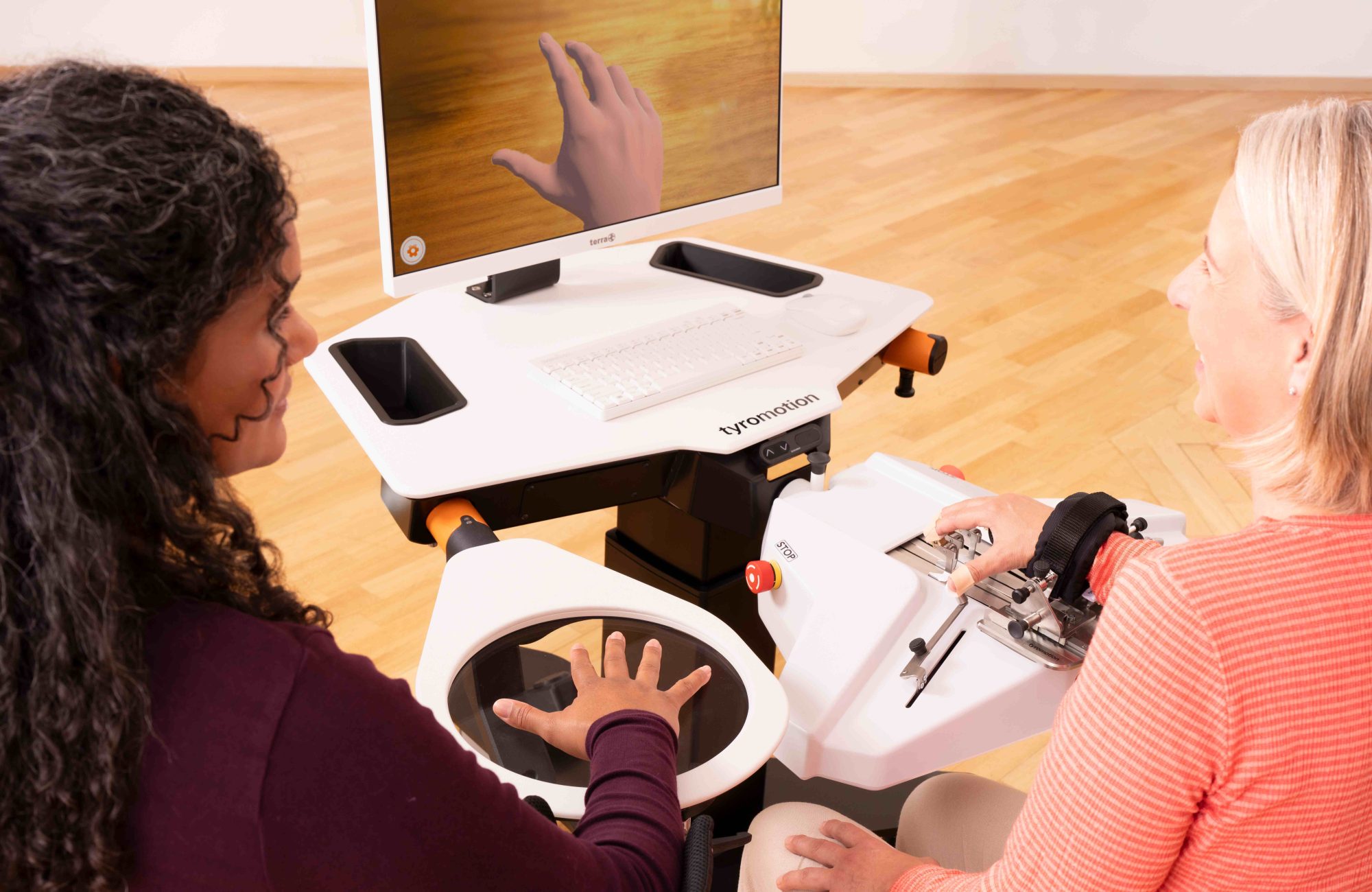 Patient trains on amadeo rmt with the support of a therapist